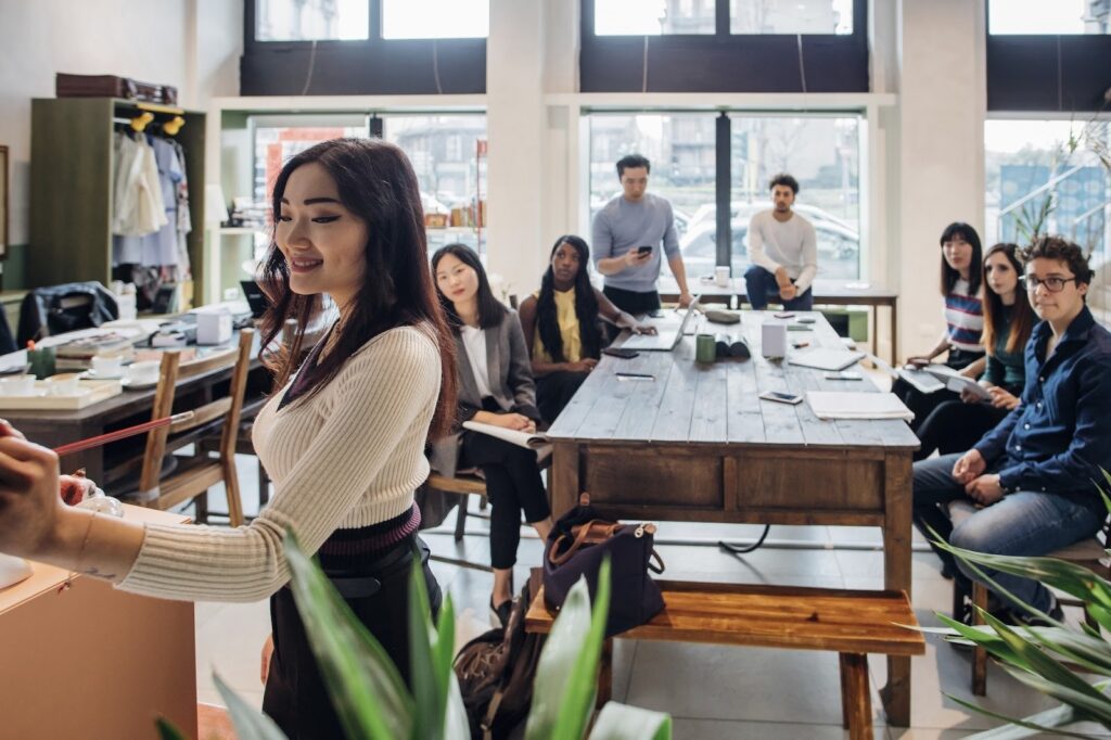 Young businesswoman making presentation for colleagues